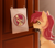 Size: 5600x4900 | Tagged: safe, artist:spika, roseluck, earth pony, pony, g4, behaving like a cat, collar, commission, commissioner:doom9454, cute, door, female, fluffy, huh i wonder who that's for, irl, mare, meme, no entry, pet tag, photo, ponies in real life, ponified animal photo, pony pet, rosepet