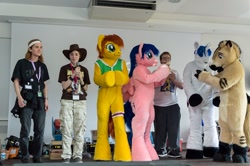 Size: 1024x681 | Tagged: safe, artist:atalonthedeer, firefly, shining armor, oc, oc:canni soda, human, galacon, g1, g4, 2012, furry, furry oc, fursuit, group, indoors, irl, irl human, photo, ponysuit, stage