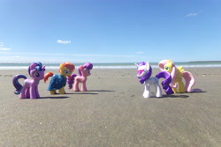 Size: 4608x3072 | Tagged: safe, artist:dingopatagonico, fluttershy, rarity, starlight glimmer, sugar belle, sunburst, pegasus, unicorn, g4, beach, horn, photo, s5 starlight, toy